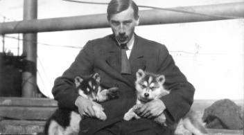 Hugh A. Peck and his pups Silver and Oscar on deck of steamer "S.S. Adventure", Churchill, MB, 1909