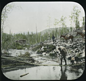 Miners crossing creek, Bonanza Trail, YT, about 1898