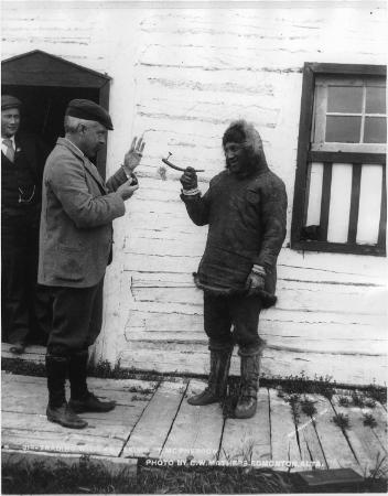 Mr. Naigle trading with an Inuit man, Fort McPherson, NT, 1901