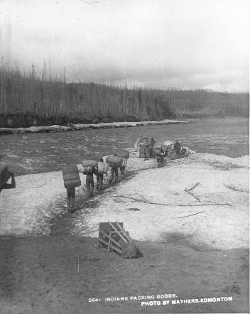 Aboriginal people portaging goods, Slave River, NT, about 1900