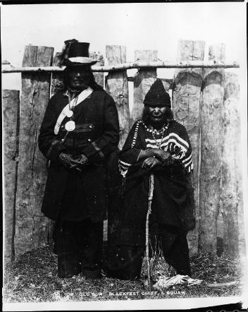 Old Sun, Niisitapiikwan chief and wife, near Calgary, AB, about 1885