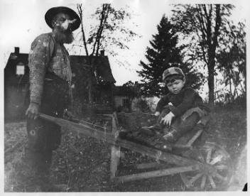 David McDougall with Millar boy in wheelbarrow, Drummondville, QC, about 1895