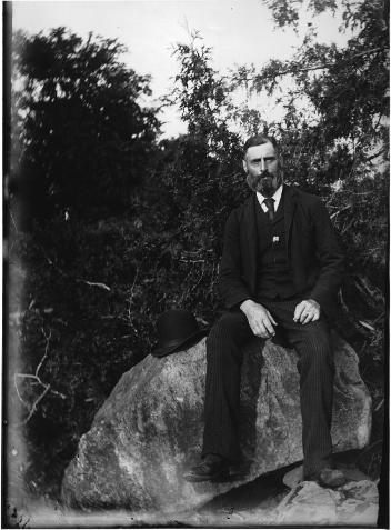 David McDougall seated on rock near Drummondville, QC, about 1895